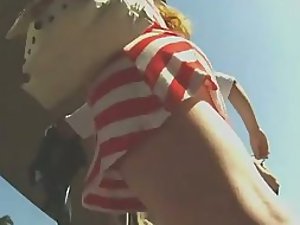 Tattoed butt under a striped skirt