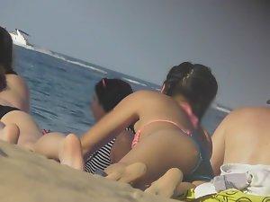 Asian teen girl bends over on beach Picture 8