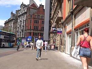 Sexy redhead keeps pulling her miniskirt down Picture 2