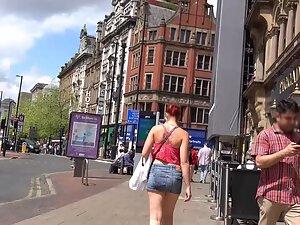 Sexy redhead keeps pulling her miniskirt down Picture 3