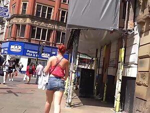 Sexy redhead keeps pulling her miniskirt down Picture 4