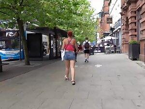 Sexy redhead keeps pulling her miniskirt down Picture 7