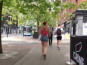 Sexy redhead keeps pulling her miniskirt down Picture 8