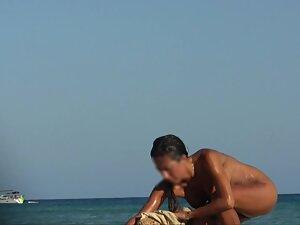 Wet nudist girl gets a hug on the beach Picture 3