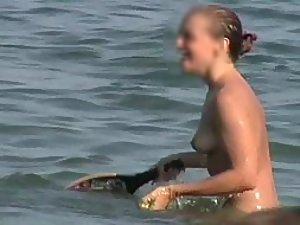 Happy topless girl playing in the water Picture 1