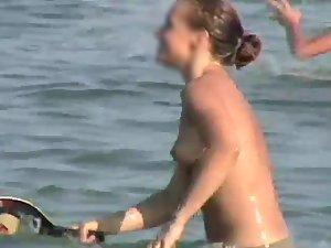 Happy topless girl playing in the water Picture 5