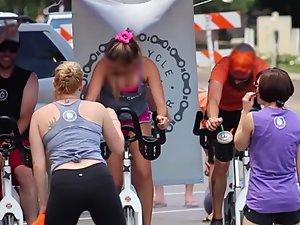 Happy busty girl during group cycling workout Picture 1