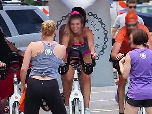Happy busty girl during group cycling workout Picture 4