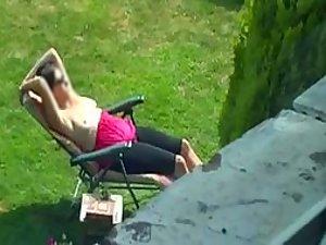 Neighbor spied while tanning her boobs