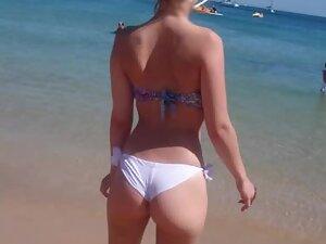 Inspection of perky ass while she has fun on beach