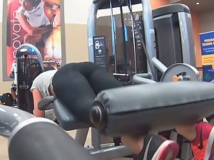 Sexy girl does leg curls in gym