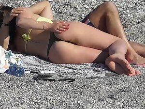 Checking her booty while she cuddles with boyfriend on beach Picture 2