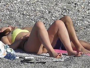 Checking her booty while she cuddles with boyfriend on beach Picture 4