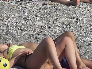 Checking her booty while she cuddles with boyfriend on beach Picture 5