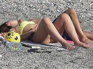 Checking her booty while she cuddles with boyfriend on beach Picture 6