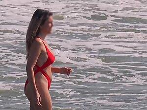 Hottie in sexy red bikini enters the water for a swim Picture 3