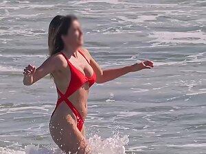 Hottie in sexy red bikini enters the water for a swim Picture 5