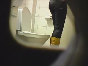 Peeping her through a public toilet hole Picture 2