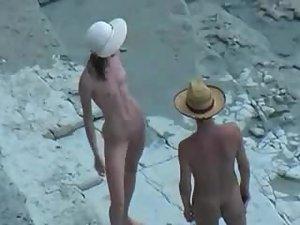 Couple with hats enjoy sex on a beach Picture 3