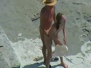 Couple with hats enjoy sex on a beach Picture 8