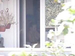Peeping on her big boobs through an open window