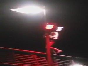 Slutty girl dances up on a bridge Picture 1