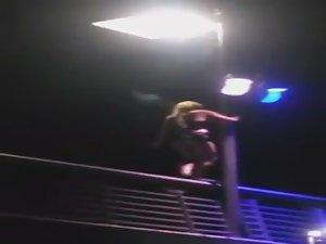 Slutty girl dances up on a bridge Picture 4