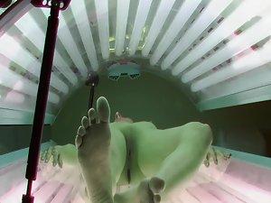 Skinny brunette peeped in a tanning bed Picture 2