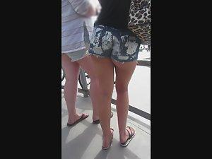One half of naked butt cheek in booty shorts Picture 1