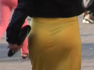 Black thong visible through sexy yellow skirt