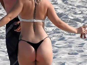Hot ass of tattooed girl dancing on the beach
