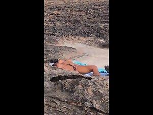 Nudist woman rubbing pussy is caught by beach voyeur