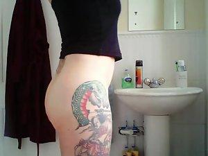 Tattooed milf spied in the bathroom Picture 2