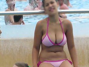 Teen with incredible big boobs on edge of swimming pool
