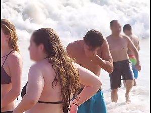 Busty ginger girl enjoys big waves in the water Picture 1