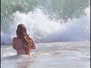 Busty ginger girl enjoys big waves in the water Picture 2
