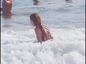 Busty ginger girl enjoys big waves in the water Picture 3