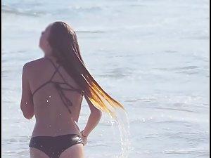 Busty ginger girl enjoys big waves in the water Picture 7