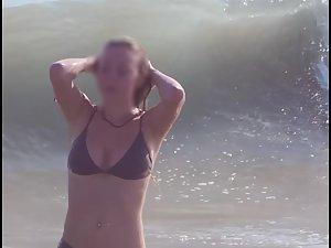 Busty ginger girl enjoys big waves in the water Picture 8