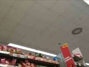 Upskirt seen when she tilts forward in the store Picture 1