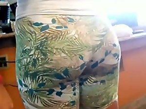 Big butt in flowery tight shorts in a store