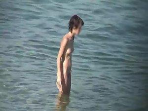 Skinny nude girl creeped on at a beach Picture 6