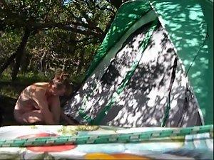 Nudist girl spied while setting her tent up Picture 3