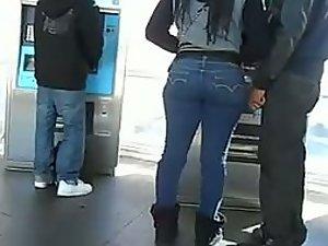 Girl with a big butt waits in a line