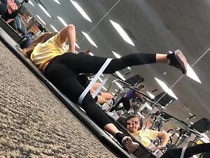 Fit girl stretching on the gym floor