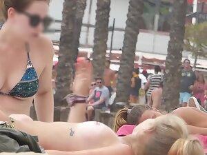 Checking out cute blonde's topless tits with a tattoo underneath