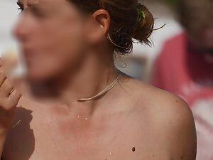 Topless milf eats fruit on the beach Picture 5