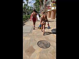 Looking hot in tiny black thong bikini and flippers in her hand Picture 4
