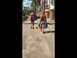 Looking hot in tiny black thong bikini and flippers in her hand Picture 5