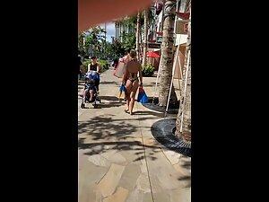 Looking hot in tiny black thong bikini and flippers in her hand Picture 7